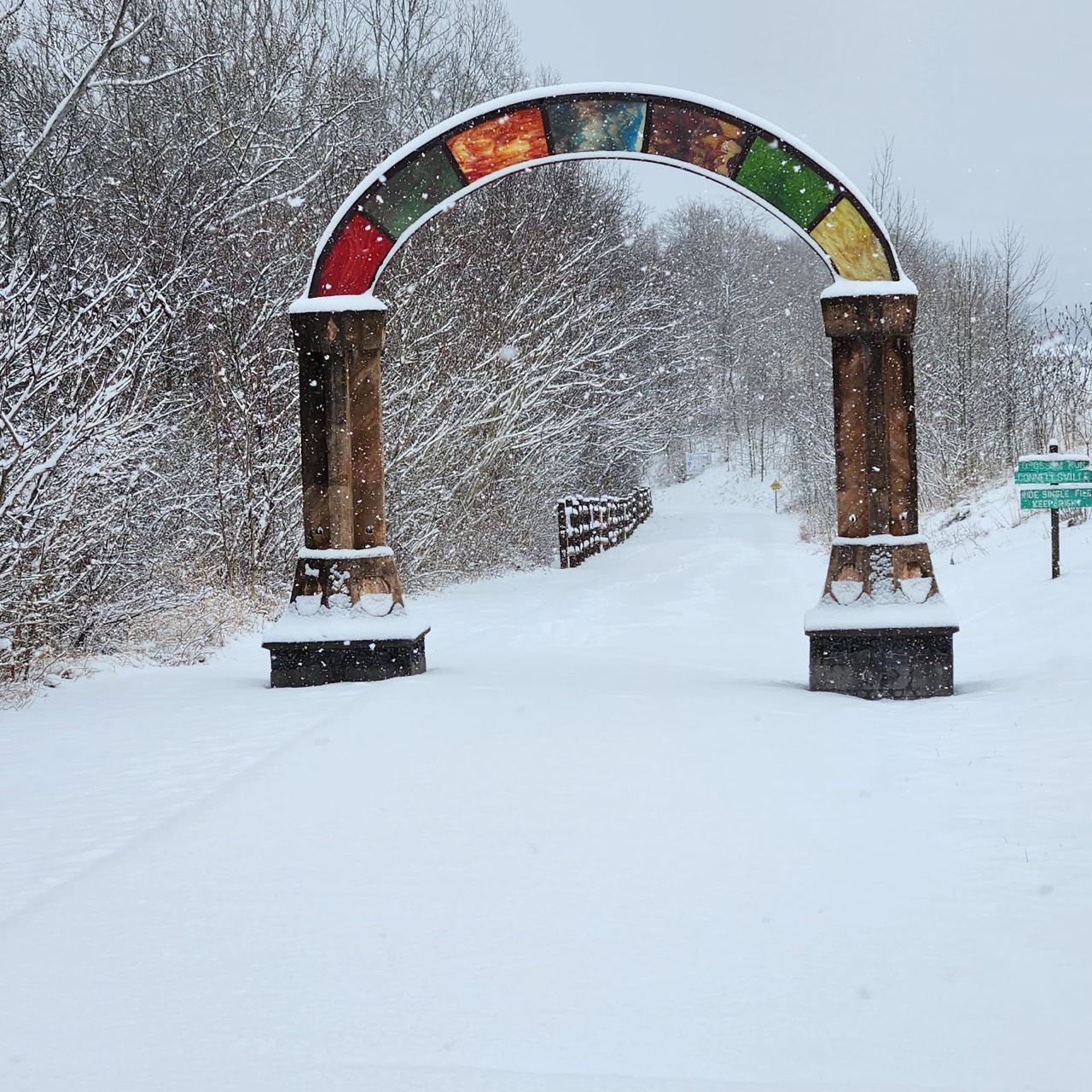 A stone railroad arch along the Yough River section of the Great Allegheny Passage